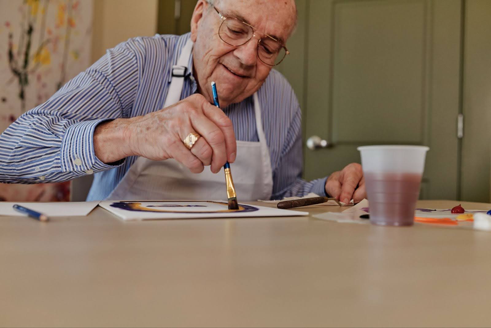 Senior man enjoying a painting glass